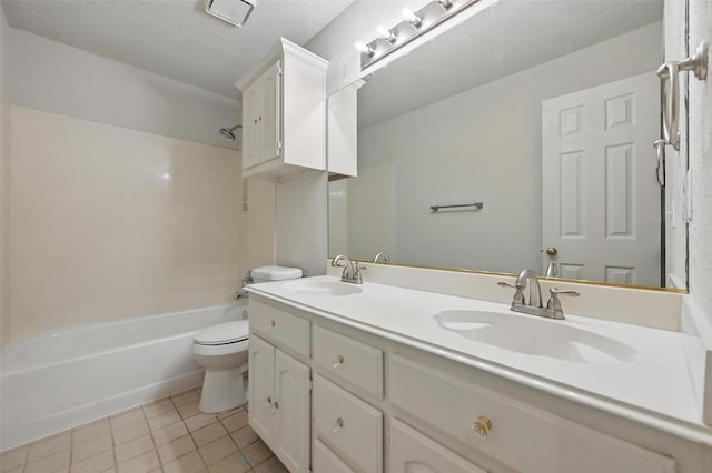 1521 Treeline Dr, Desoto, TX 75115 - full bathroom featuring toilet, double vanity, tile patterned floors, washtub / shower combination, and a textured ceiling