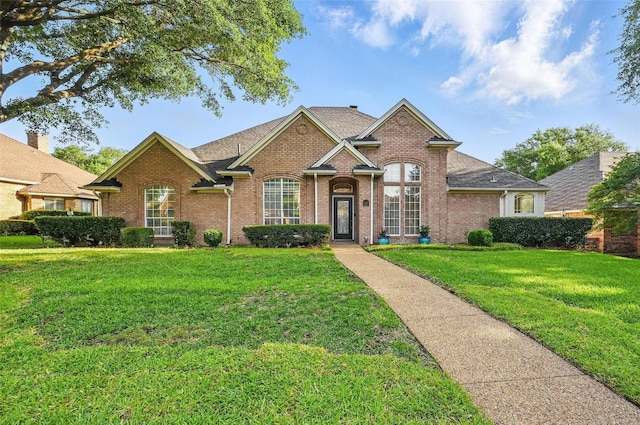 1521 Treeline Dr, Desoto, TX 75115 - traditional-style home featuring brick siding, a front lawn, and a shingled roof