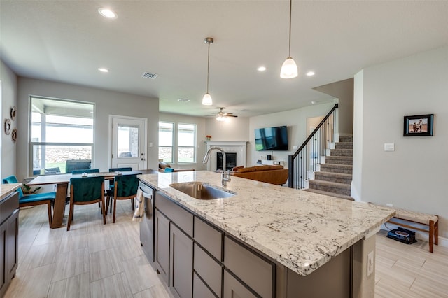 1824 Rachel St, Northlake, TX 76247 - kitchen featuring a sink, stainless steel dishwasher, a fireplace, light stone counters, and open floor plan