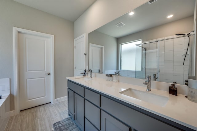 1824 Rachel St, Northlake, TX 76247 - bathroom featuring double vanity, a shower stall, a garden tub, baseboards, and recessed lighting