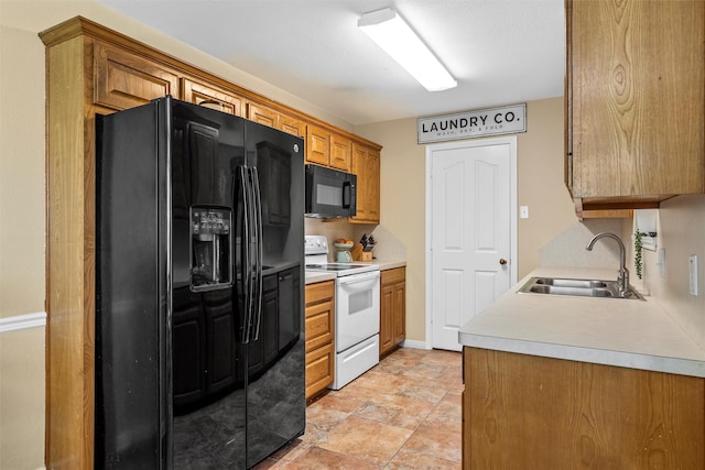 10400 Marigold Rd, Waco, TX 76708 - kitchen featuring black appliances, a sink, light countertops, brown cabinetry, and stone finish flooring