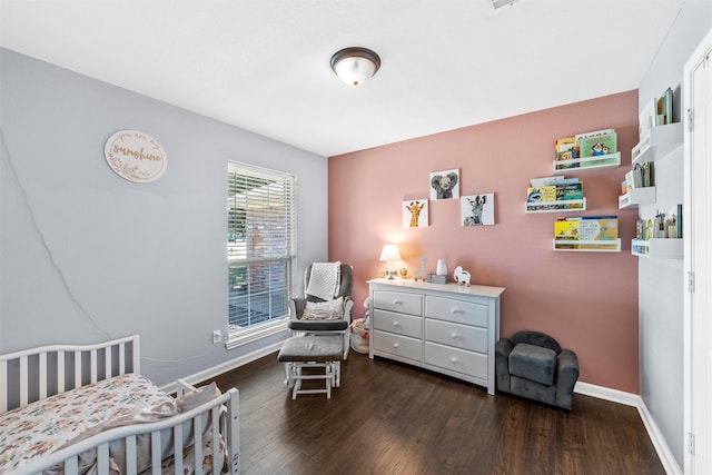 10400 Marigold Rd, Waco, TX 76708 - bedroom featuring baseboards, wood finished floors, and a crib