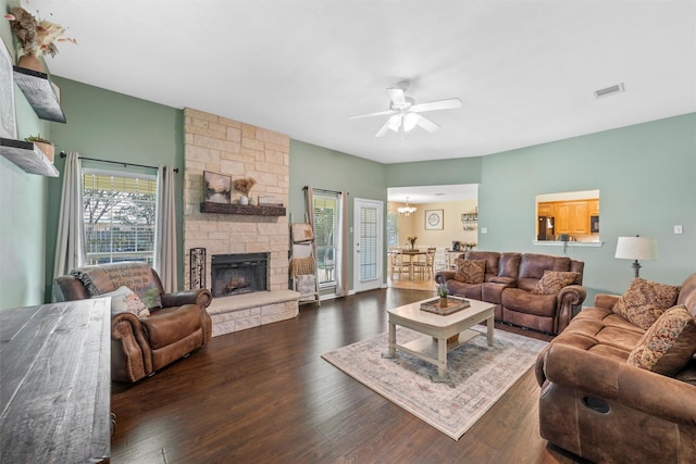 10400 Marigold Rd, Waco, TX 76708 - living area with ceiling fan, wood finished floors, and a stone fireplace