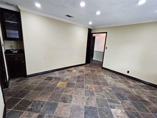 236 La Jolla Dr, Athens, TX 75751 - unfurnished room featuring baseboards, recessed lighting, ornamental molding, a sink, and dark stone finish floors
