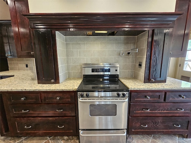236 La Jolla Dr, Athens, TX 75751 - kitchen with stainless steel electric range, decorative backsplash, light stone countertops, and dark brown cabinets