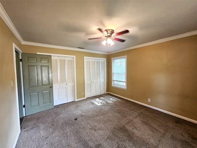 236 La Jolla Dr, Athens, TX 75751 - unfurnished bedroom featuring multiple closets, crown molding, carpet, baseboards, and a ceiling fan