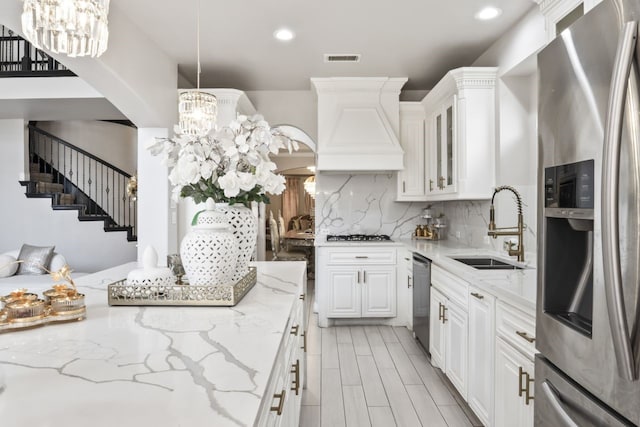 14237 Sugar Hill Dr, Little Elm, TX 75068 - kitchen with stainless steel appliances, a sink, a chandelier, premium range hood, and recessed lighting