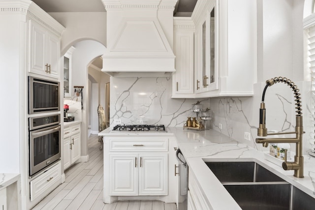 14237 Sugar Hill Dr, Little Elm, TX 75068 - kitchen featuring stainless steel appliances, a sink, premium range hood, white cabinetry, and tasteful backsplash