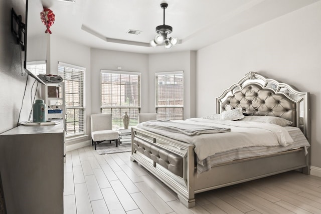 14237 Sugar Hill Dr, Little Elm, TX 75068 - bedroom with a raised ceiling, light wood-style floors, and baseboards