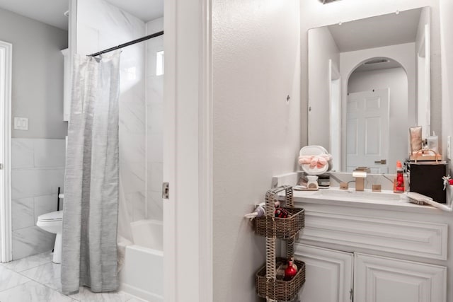 14237 Sugar Hill Dr, Little Elm, TX 75068 - bathroom featuring toilet, vanity, shower / tub combo with curtain, marble finish flooring, and tile walls
