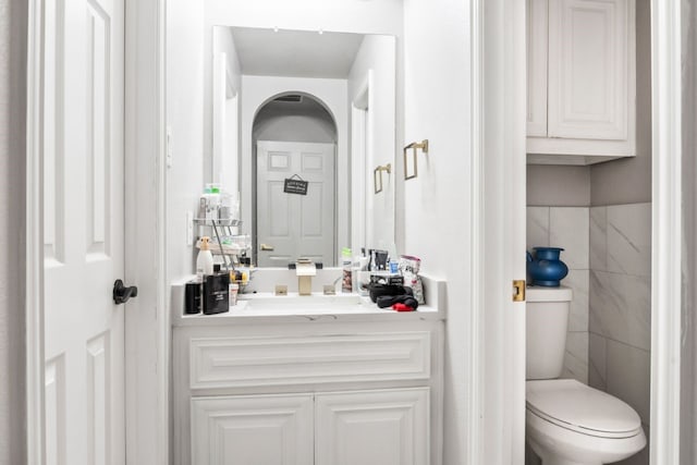 14237 Sugar Hill Dr, Little Elm, TX 75068 - bathroom featuring vanity, toilet, and tile walls