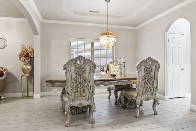 14237 Sugar Hill Dr, Little Elm, TX 75068 - dining area with arched walkways, wood tiled floors, a chandelier, and ornamental molding
