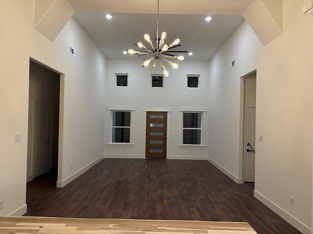 5518 Cold Water Trl, Granbury, TX 76048 - unfurnished living room with baseboards, a chandelier, wood finished floors, recessed lighting, and a towering ceiling
