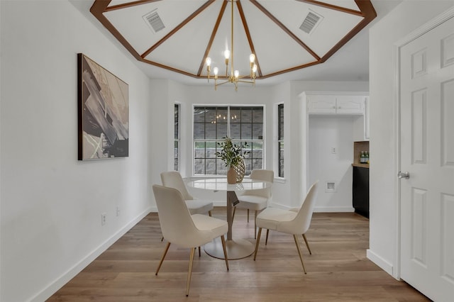 4909 Berkeley Ct, Garland, TX 75043 - dining room with a chandelier, light wood-type flooring, and baseboards