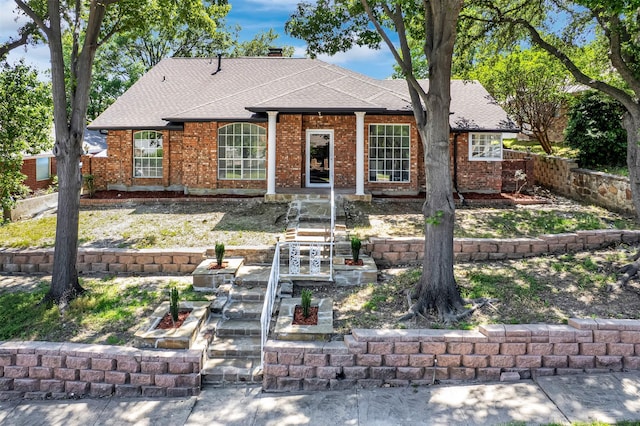 4909 Berkeley Ct, Garland, TX 75043 - ranch-style home featuring roof with shingles and brick siding