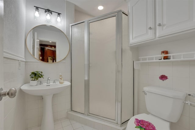 4909 Berkeley Ct, Garland, TX 75043 - full bathroom featuring tile walls, a stall shower, toilet, and tile patterned floors