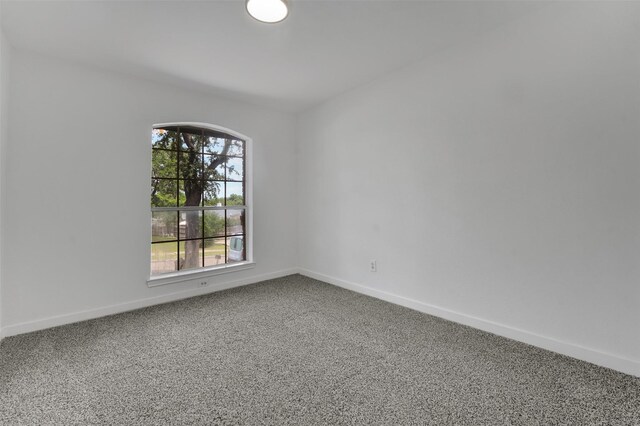 4909 Berkeley Ct, Garland, TX 75043 - spare room featuring carpet floors and baseboards