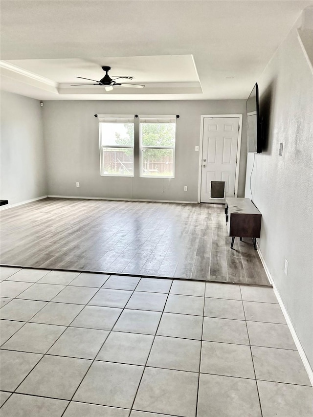 2237 Heaton St, Forney, TX 75126 - empty room with a tray ceiling, light wood-type flooring, and a ceiling fan