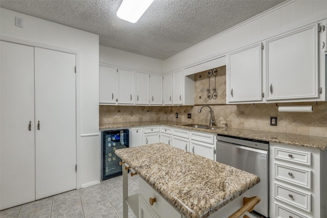 6400 Kingswood Dr, Fort Worth, TX 76133 - kitchen featuring beverage cooler, a sink, stainless steel dishwasher, a textured ceiling, and tasteful backsplash