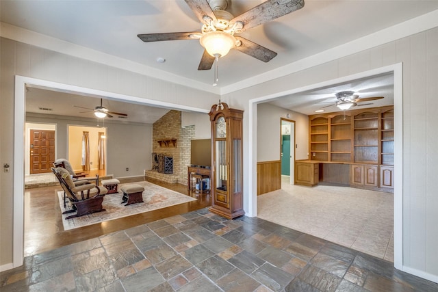 6400 Kingswood Dr, Fort Worth, TX 76133 - living area featuring ceiling fan, a fireplace, built in features, and stone tile flooring