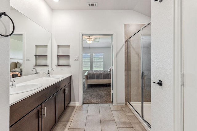 101 Lisa Ln, Royse City, TX 75189 - bathroom featuring connected bathroom, double vanity, a ceiling fan, a shower stall, and built in shelves