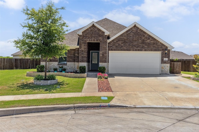 101 Lisa Ln, Royse City, TX 75189 - view of front facade with brick siding, an attached garage, a shingled roof, and concrete driveway