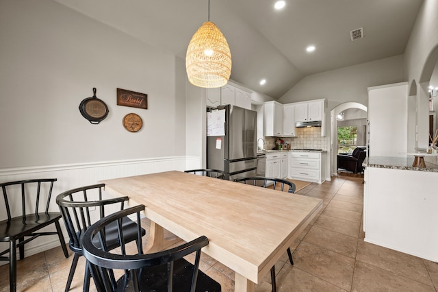 11404 Grapeleaf Dr, Fort Worth, TX 76244 - dining room with arched walkways, lofted ceiling, and a wainscoted wall