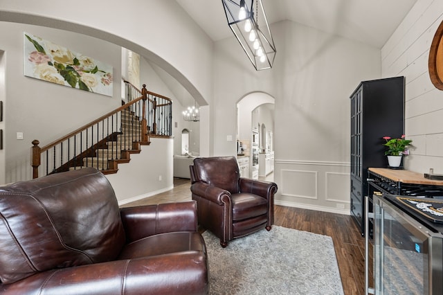 11404 Grapeleaf Dr, Fort Worth, TX 76244 - living area featuring arched walkways, high vaulted ceiling, dark wood finished floors, and stairs
