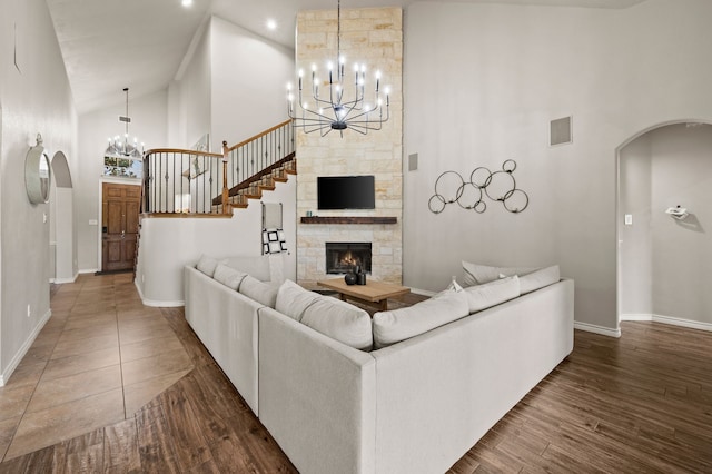 11404 Grapeleaf Dr, Fort Worth, TX 76244 - living area with high vaulted ceiling, arched walkways, a chandelier, baseboards, and wood finished floors
