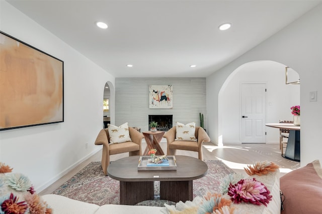 1720 Meadow Valley Ln, Dallas, TX 75232 - living area with arched walkways, wood finished floors, a fireplace, recessed lighting, and baseboards