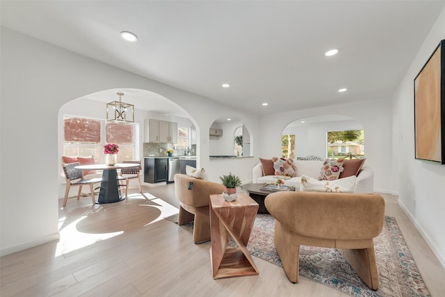 1720 Meadow Valley Ln, Dallas, TX 75232 - living room featuring arched walkways, light wood-style flooring, recessed lighting, and baseboards