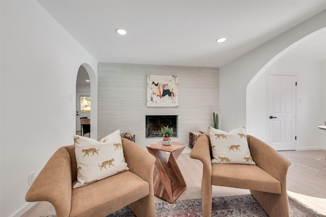1720 Meadow Valley Ln, Dallas, TX 75232 - living area with arched walkways, recessed lighting, wood finished floors, a fireplace, and baseboards
