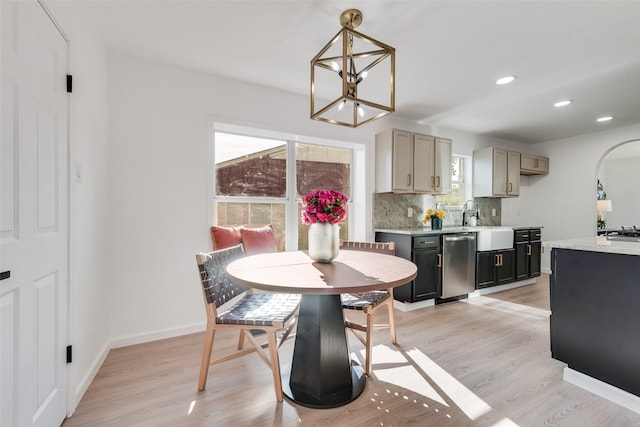 1720 Meadow Valley Ln, Dallas, TX 75232 - dining space featuring a chandelier, light wood-style floors, recessed lighting, baseboards, and arched walkways