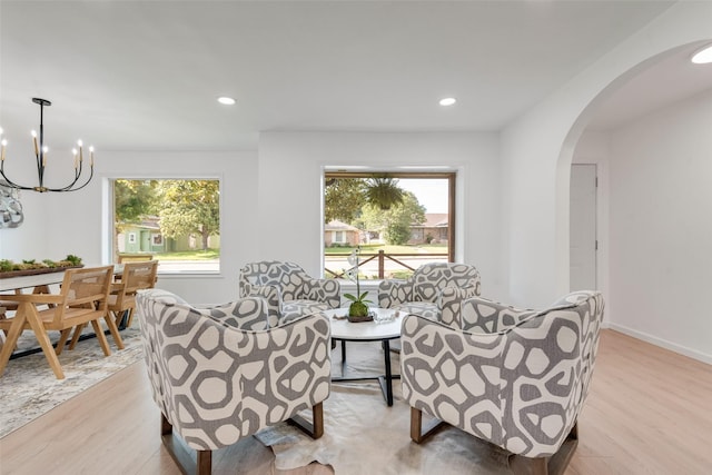 1720 Meadow Valley Ln, Dallas, TX 75232 - living room with light wood-style floors, healthy amount of natural light, arched walkways, a chandelier, and recessed lighting