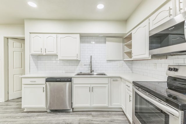 3527 Palm Dr, Mesquite, TX 75150 - kitchen featuring stainless steel appliances, a sink, white cabinets, light countertops, and open shelves