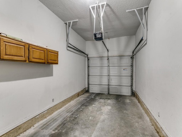 7151 Gaston Ave Unit 906, Dallas, TX 75214 - garage featuring baseboards and a garage door opener