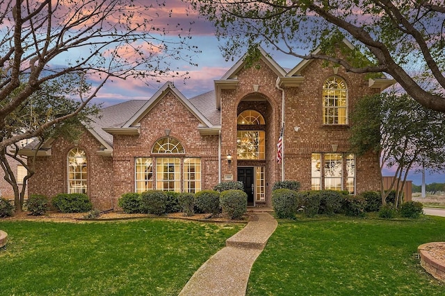 1529 Arrowhead Ln, Carrollton, TX 75007 - traditional home with brick siding, a yard, and roof with shingles