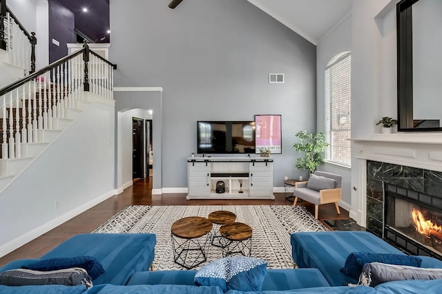 1529 Arrowhead Ln, Carrollton, TX 75007 - living area featuring high vaulted ceiling, a high end fireplace, wood finished floors, and baseboards