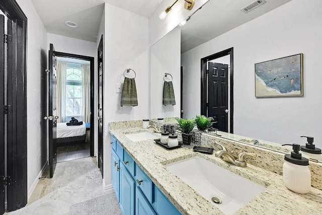 1529 Arrowhead Ln, Carrollton, TX 75007 - ensuite bathroom featuring double vanity and baseboards
