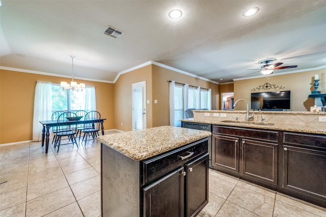 5710 Salisbury Dr, Prosper, TX 75078 - kitchen featuring a sink, light tile patterned floors, a chandelier, ornamental molding, and a kitchen island
