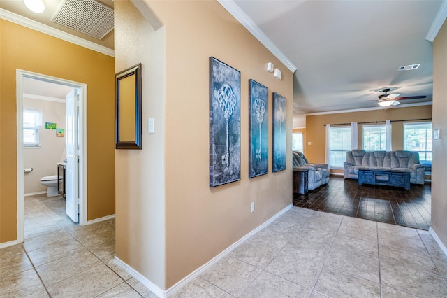5710 Salisbury Dr, Prosper, TX 75078 - hall with crown molding, healthy amount of natural light, baseboards, tile patterned flooring, and arched walkways