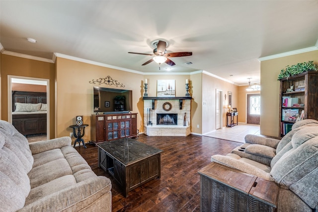 5710 Salisbury Dr, Prosper, TX 75078 - living room featuring hardwood / wood-style floors, a ceiling fan, ornamental molding, a stone fireplace, and baseboards