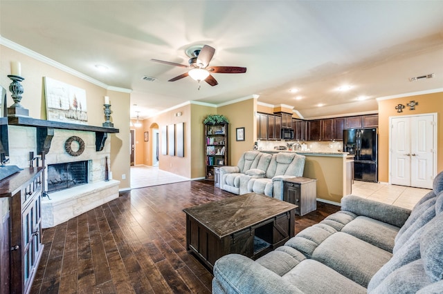 5710 Salisbury Dr, Prosper, TX 75078 - living area with ceiling fan, crown molding, recessed lighting, light wood-type flooring, and a stone fireplace