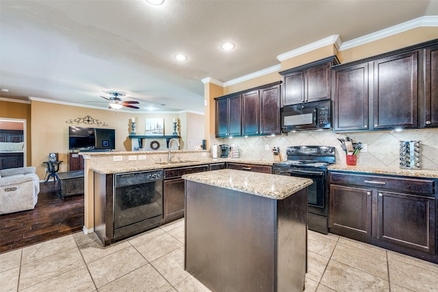 5710 Salisbury Dr, Prosper, TX 75078 - kitchen featuring black appliances, a sink, open floor plan, light stone countertops, and ornamental molding