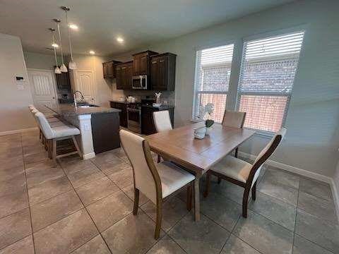 1037 Madelia Ave, Fort Worth, TX 76177 - dining area featuring baseboards, light tile patterned floors, and recessed lighting