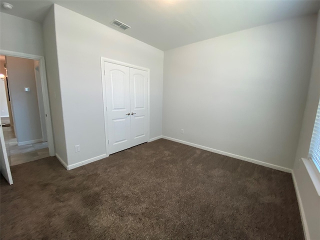 1037 Madelia Ave, Fort Worth, TX 76177 - unfurnished bedroom featuring dark colored carpet, a closet, and baseboards