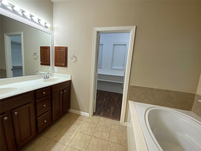 1705 Spanish Moss Way, Savannah, TX 76227 - full bathroom featuring a bath, double vanity, tile patterned flooring, and a spacious closet