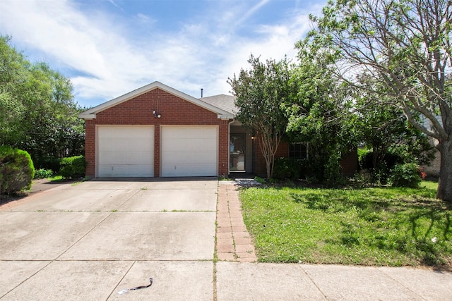 4512 Blue Jay Ln, Sherman, TX 75092 - view of front of home featuring brick siding, an attached garage, concrete driveway, and a front yard