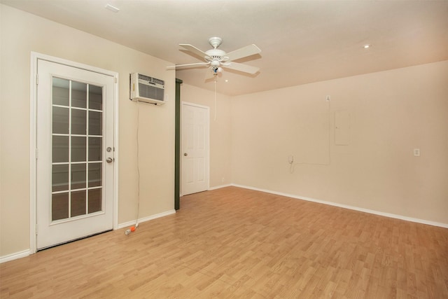4512 Blue Jay Ln, Sherman, TX 75092 - empty room featuring a wall mounted AC, light wood-type flooring, a ceiling fan, and baseboards