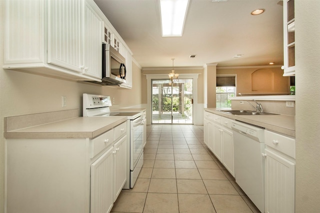 4512 Blue Jay Ln, Sherman, TX 75092 - kitchen featuring white appliances, a sink, light tile patterned floors, light countertops, and ornamental molding